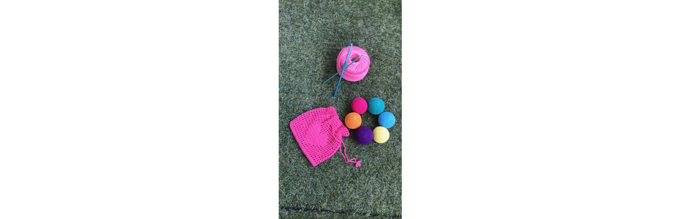 Baby playing rattle colouring balls.